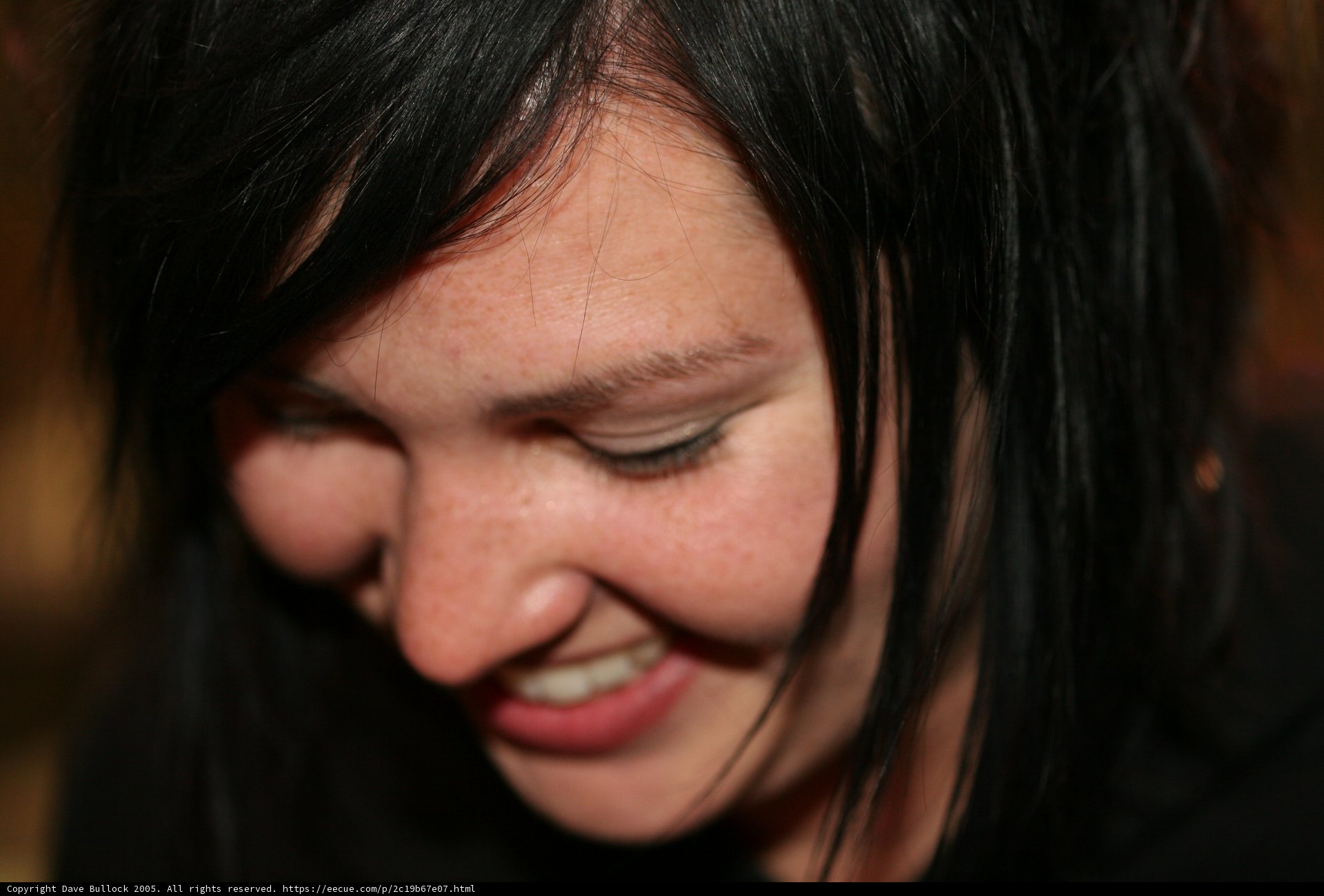 Black-Haired Woman Beaming with Joy