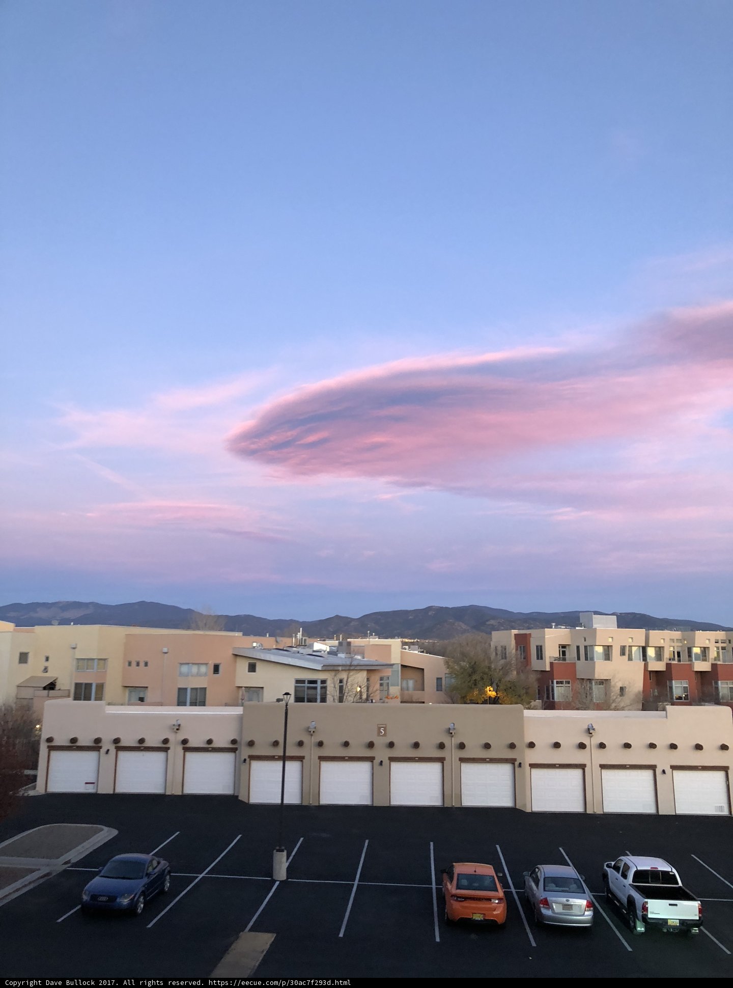 Pink Clouds Above a Busy Parking Lot