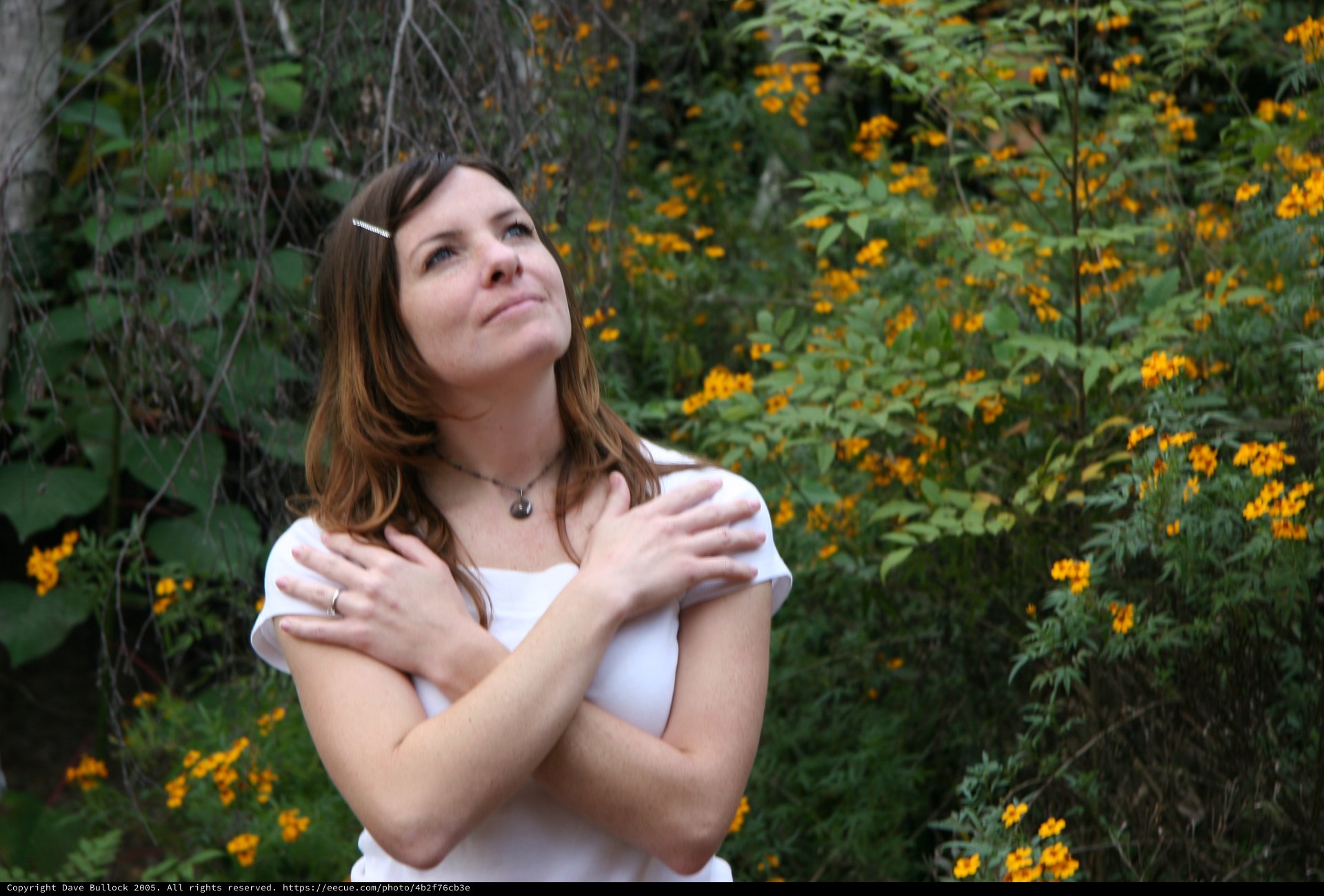 Woman in White Gazing Upward Among Wildflowers