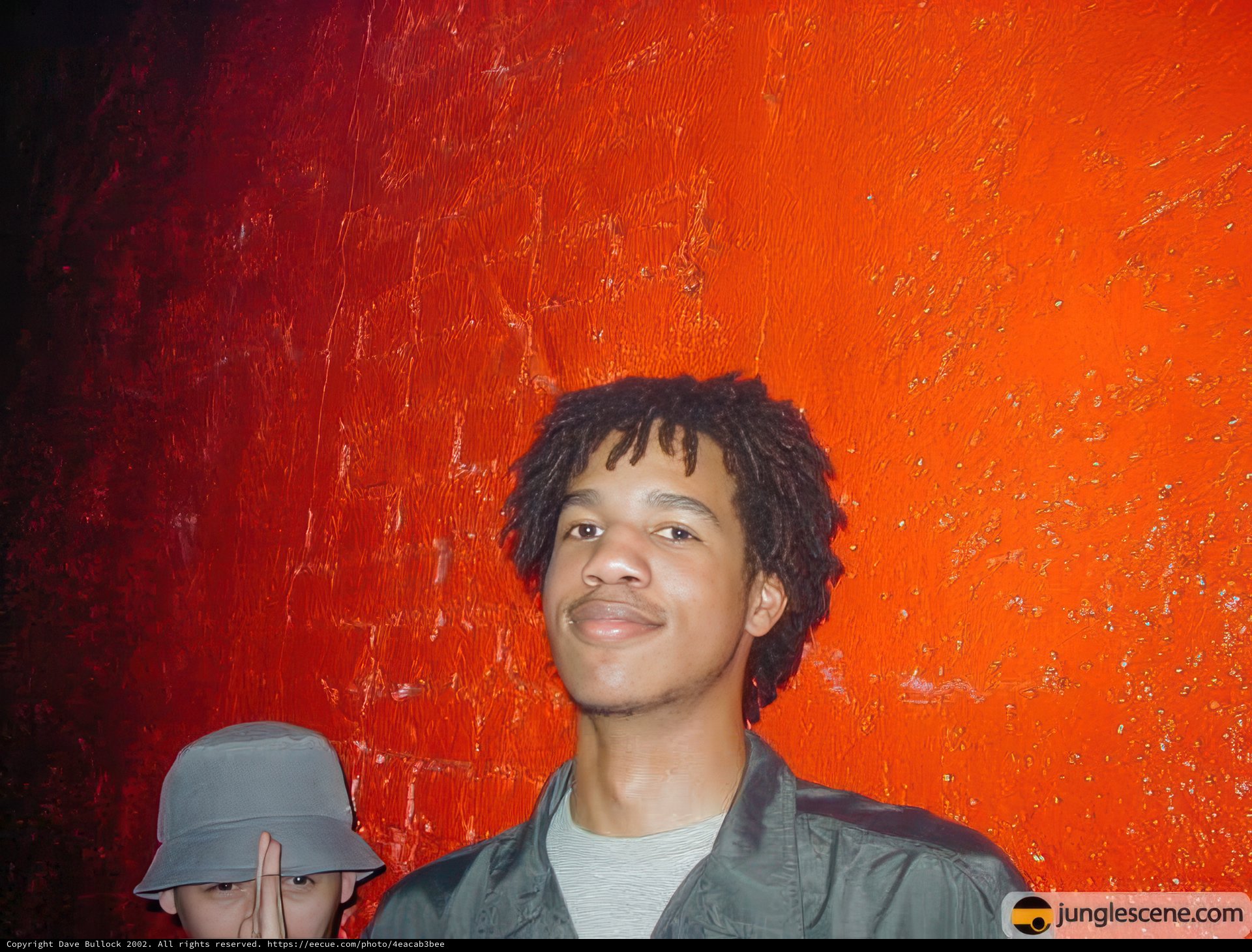 Ron posing next to a brick wall