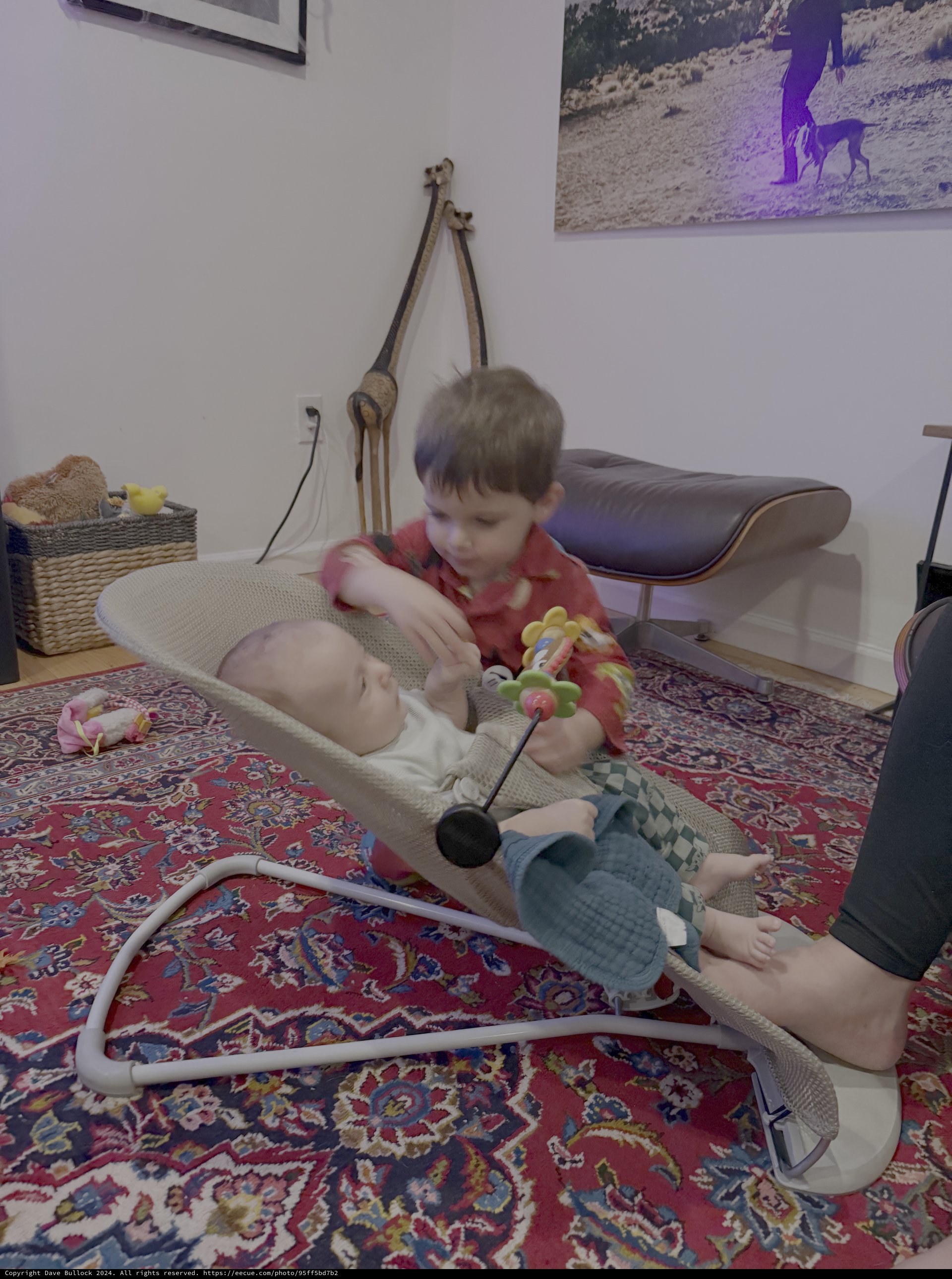 Older Brother Playing with Baby on Bouncy Seat