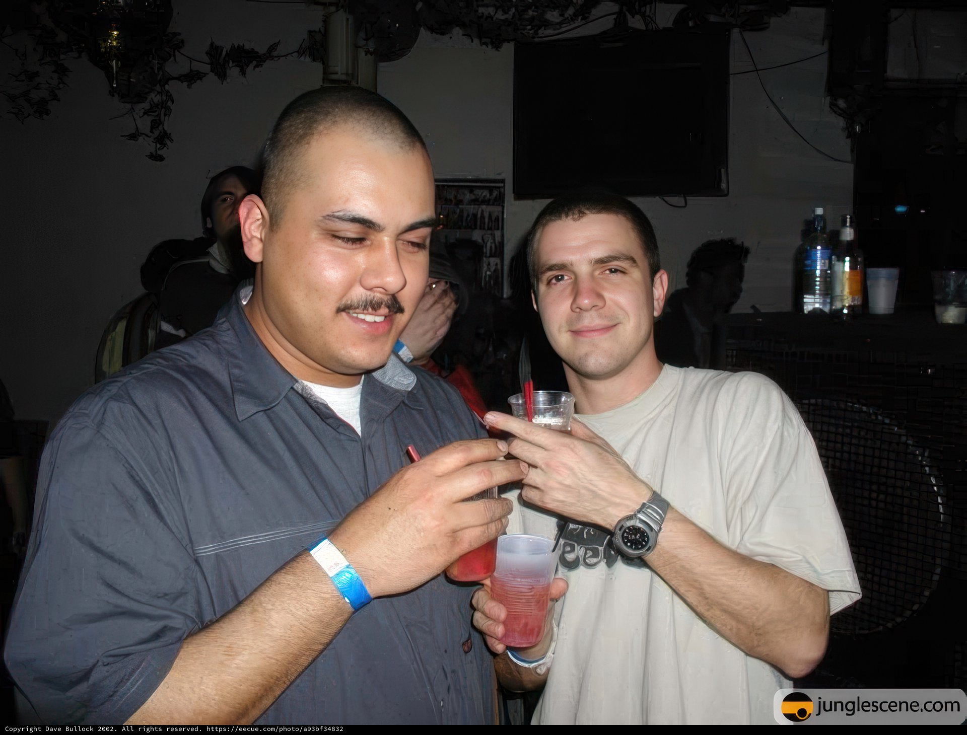 Two Men Enjoying Drinks at Nightclub