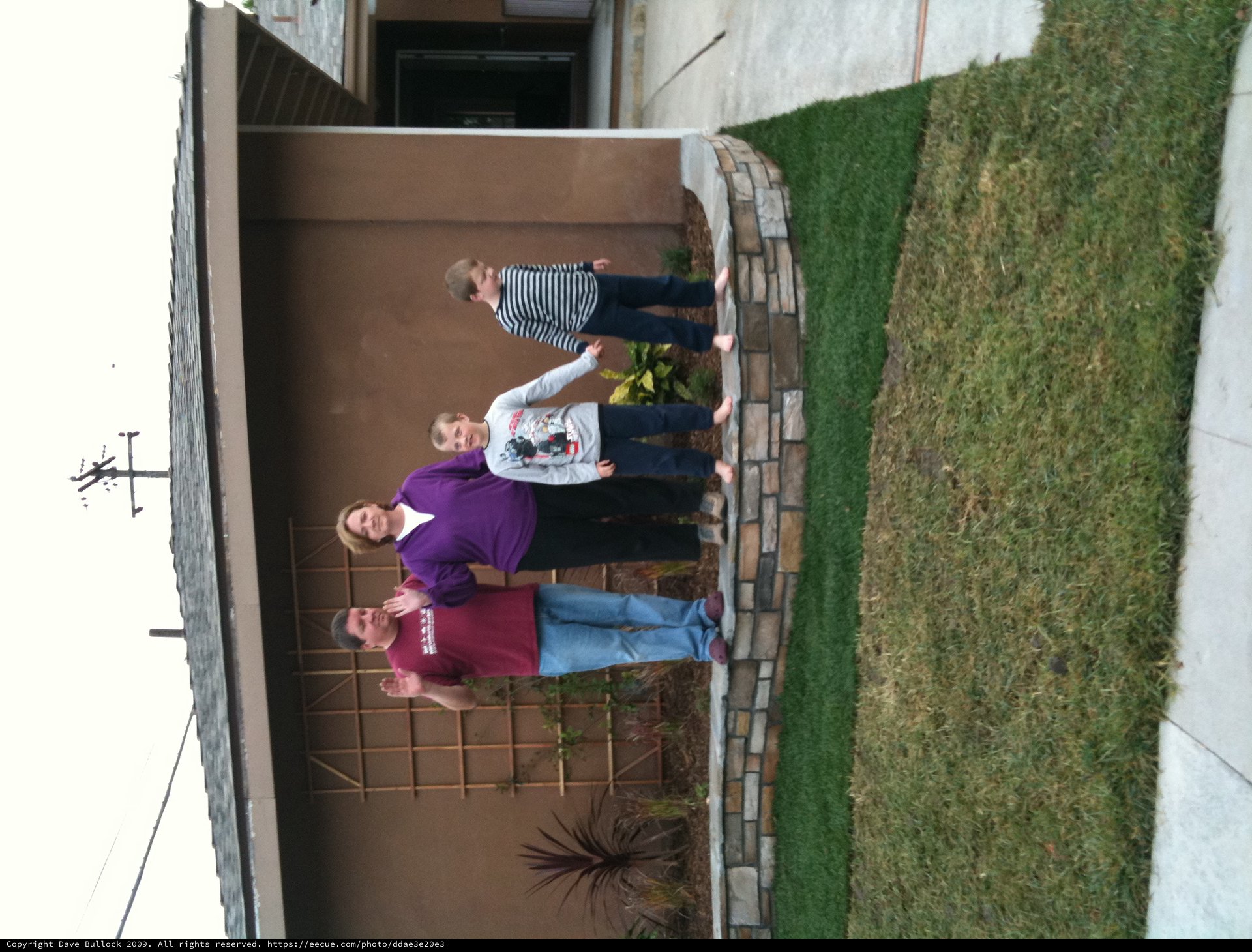Family Waving Together in Front of Home