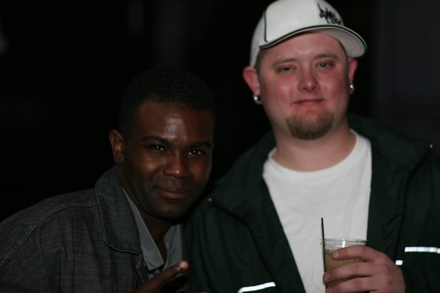 Two men enjoying drinks at the Bass Rush 4 Year celebration