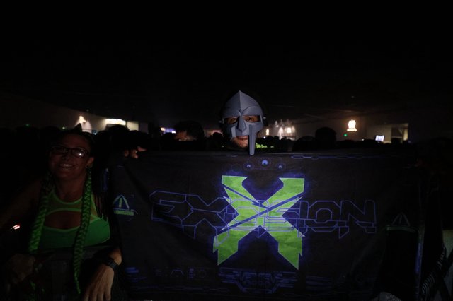 MF DOOM Mask Fan Holds Excision Banner at Wobbleland