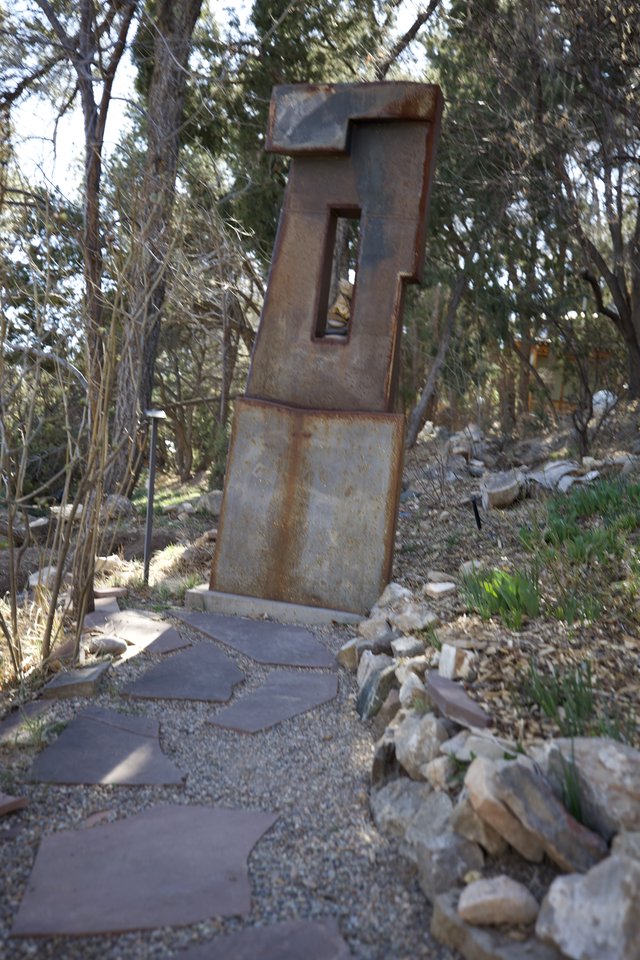 Rusted Metal Sculpture in Wooded Garden Setting
