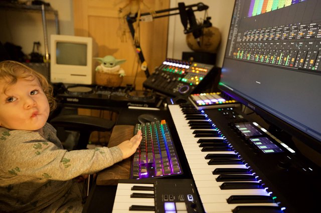 Young Child Explores Music Production Studio Setup