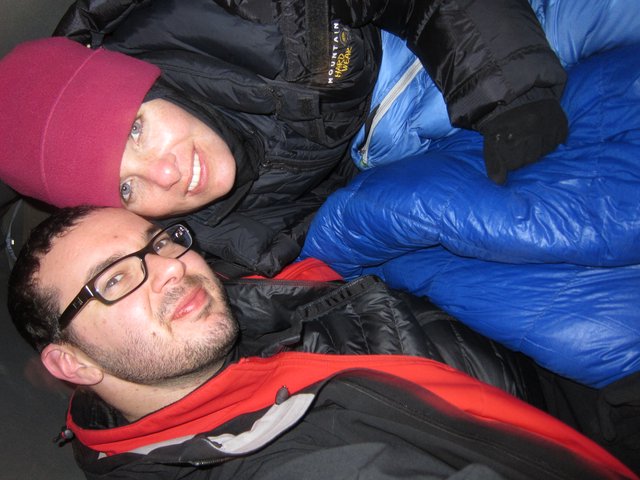 Bundled Up Friends Sharing Warmth on Cold Night
