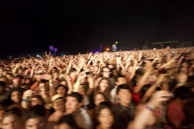 Coachella's electrifying crowd under the night sky