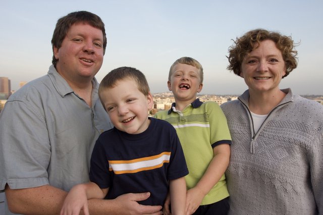 Happy Family Portrait on City Rooftop at Dusk
