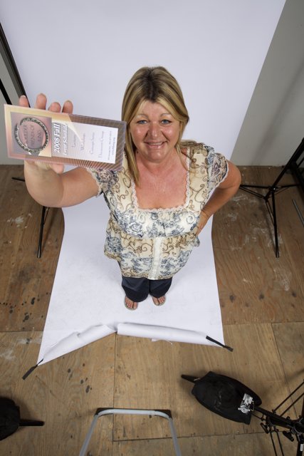 Woman Holding a Paper with Hardwood Flooring Background