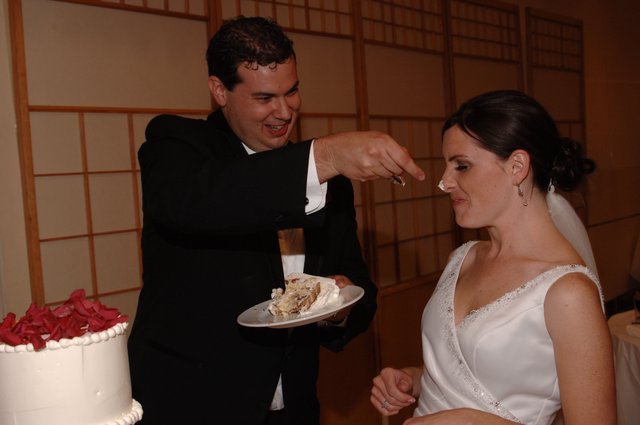 Groom Smears Wedding Cake on Bride's Nose
