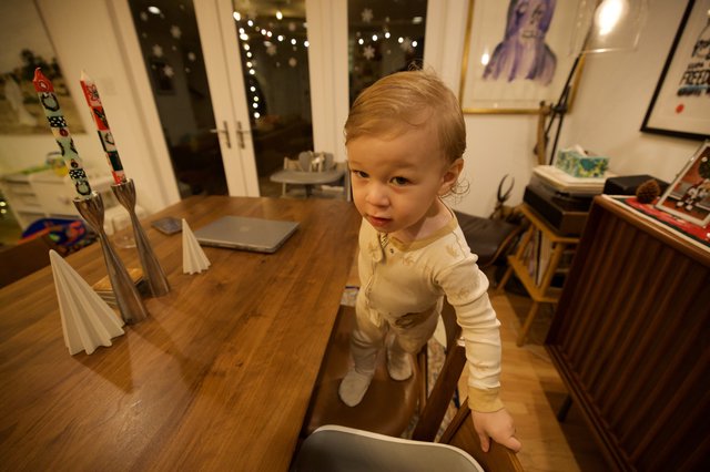 Curious Toddler at Wooden Dining Table in Modern Home