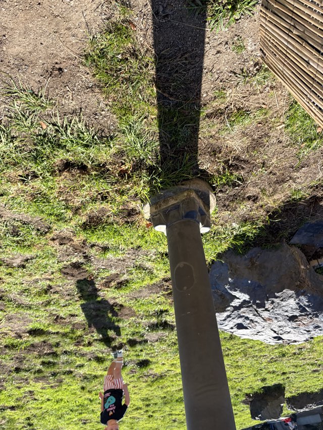 Aerial View of Person Relaxing by Garden Post