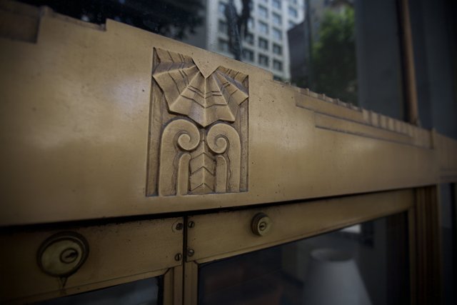 The Intricate Wooden Emblem on the Golden Monastery Door