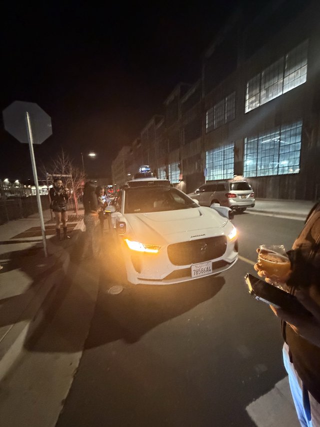 White Sedan on Urban Street at Night