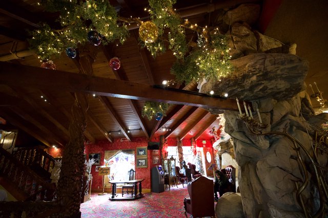Festive Christmas Lodge Interior with Rustic Stone Fireplace