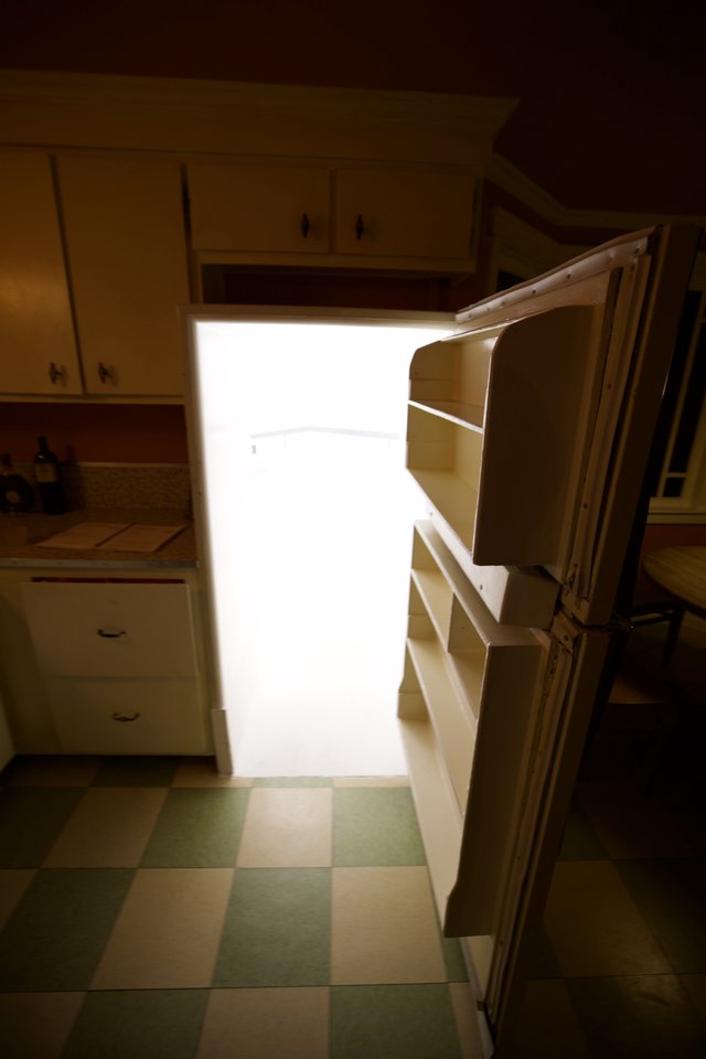 Bright Light Spilling from Open Refrigerator in Kitchen