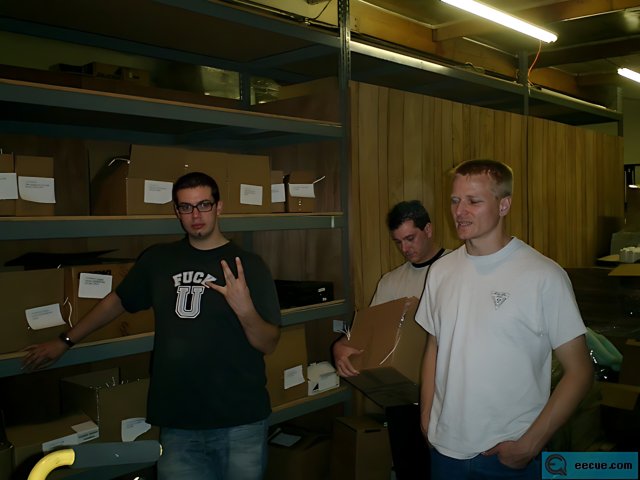 Three Men in a Clothing Warehouse
