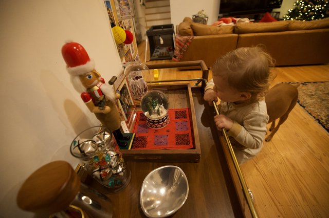 Child Admiring Christmas Decorations at Home
