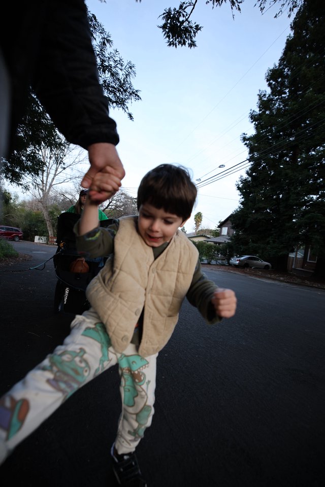 Child's Joyful Stride on Suburban Evening Walk
