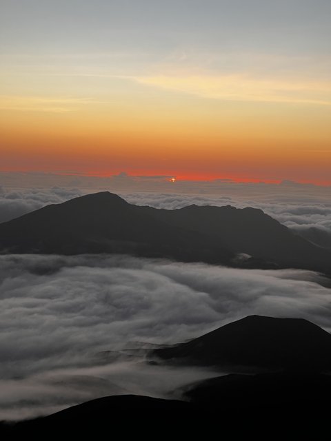 Summit Sunrise: Above the Clouds