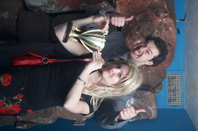 Victory Pose: Halloween Winners Celebrate with Trophy