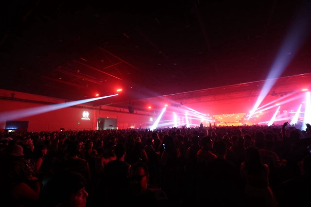 Massive Indoor Rave Ignites Under Red Light Beams