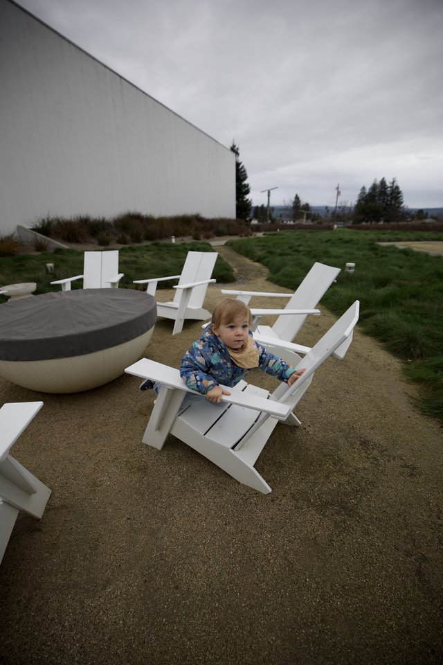 Toddler Relaxing in Adirondack Chair on Cloudy Day
