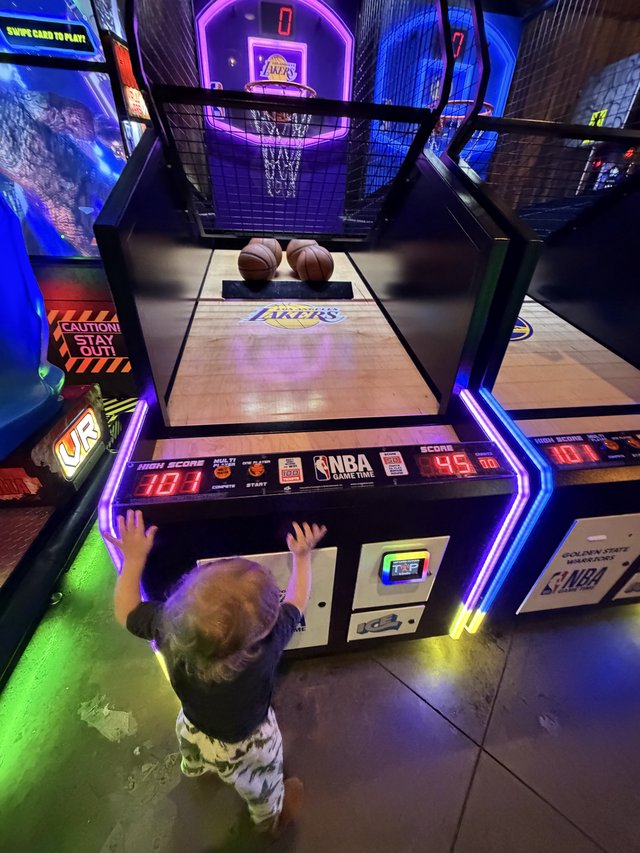 Young Child Playing NBA Basketball Arcade Game