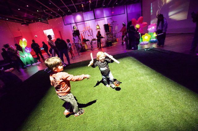 Children Playing with Light Sticks at Baby Rave Event