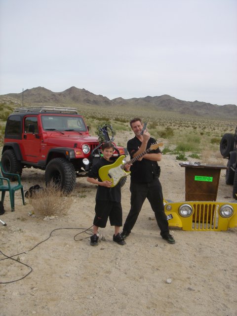 Father and Son Take a Break to Jam in the Desert