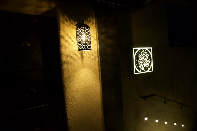 Moroccan-Inspired Lantern Casting Shadows in Dark Corridor