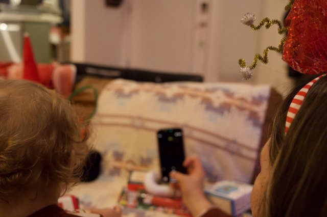 Children Capturing Christmas Morning Memories with Phone