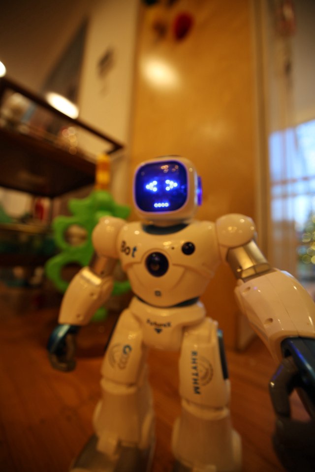 Small White Robot Toy with Blue Digital Face Display