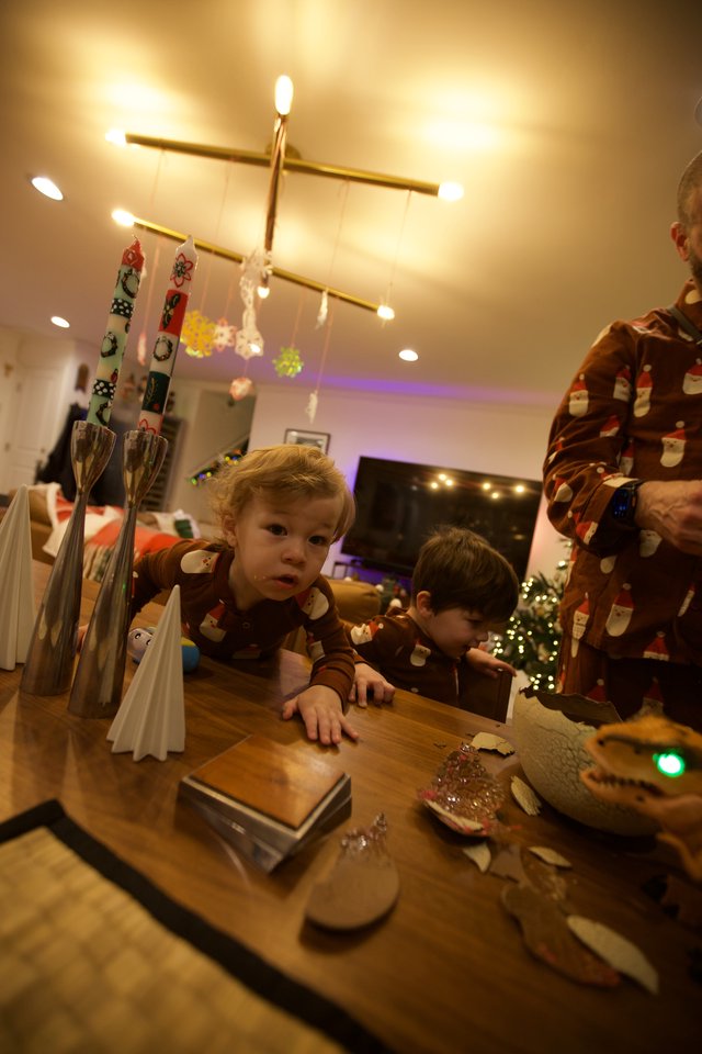 Children in Festive Pajamas at Christmas Table