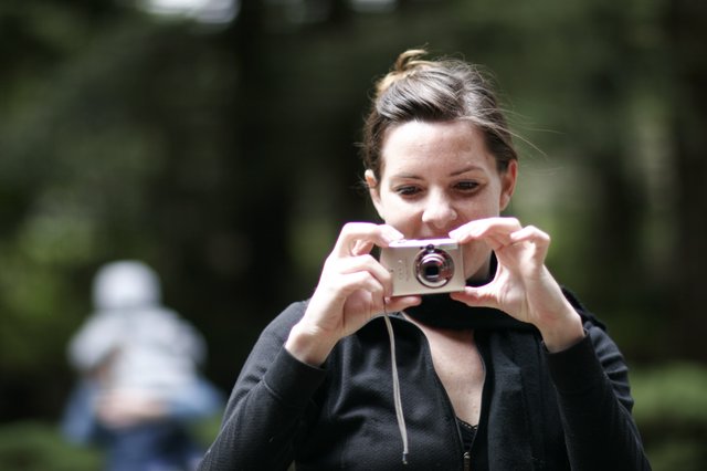 Woman Captures Memories with Compact Camera Outdoors