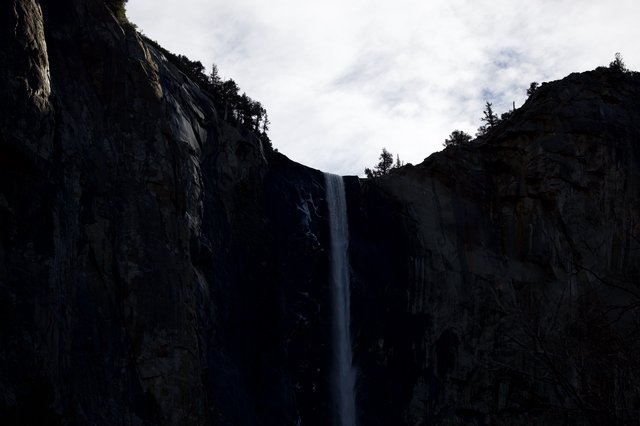 Waterfall Through Shadowed Granite Cliffs in Yosemite