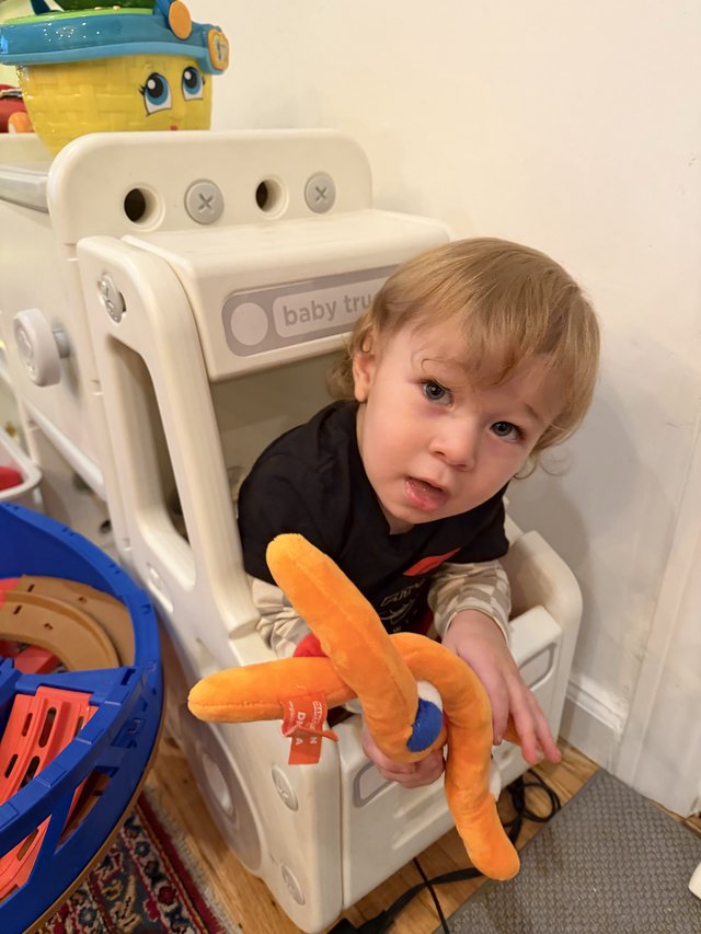 Toddler Playing in White Toy Truck