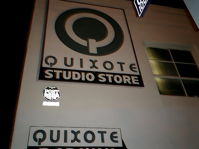 Quixote Studio Store Sign at Night