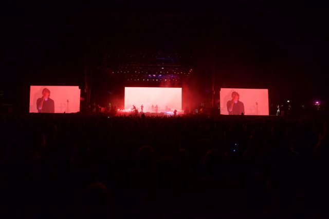 Red Lights Illuminate Concert Screen