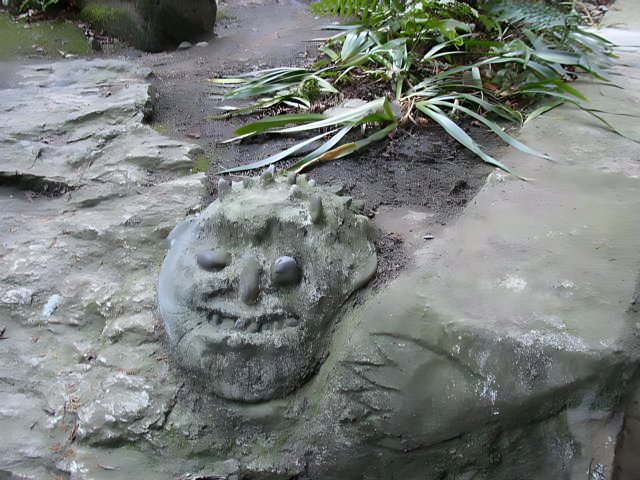 Sculpted Stone Face in Garden