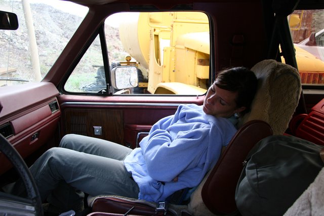 Weary Traveler Napping in a Vintage Truck Cab