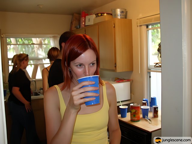 Red-haired woman enjoying a beverage in the kitchen