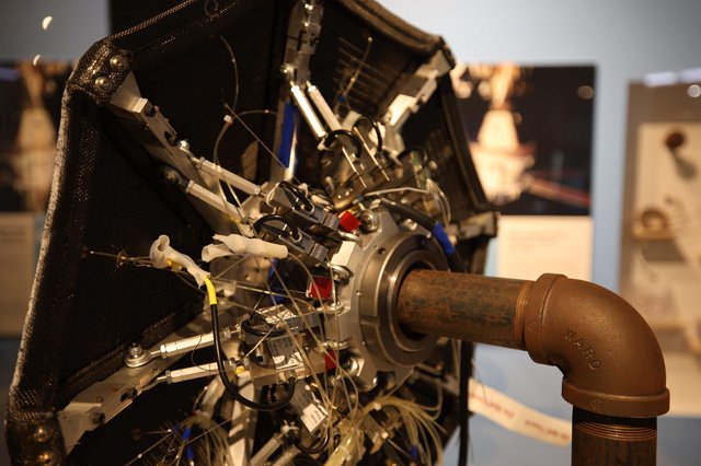 Vintage Aircraft Engine with Curved Exhaust Pipe Display