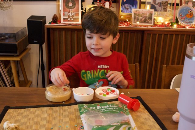 Young Boy Making Christmas Grinch Play Dough Creation