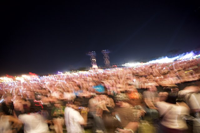 Blurry Nighttime Concert Crowd