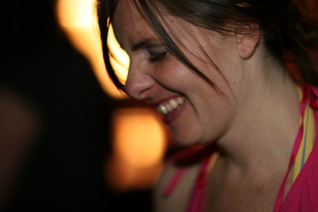 Laughing Woman Glowing in Warm Party Light