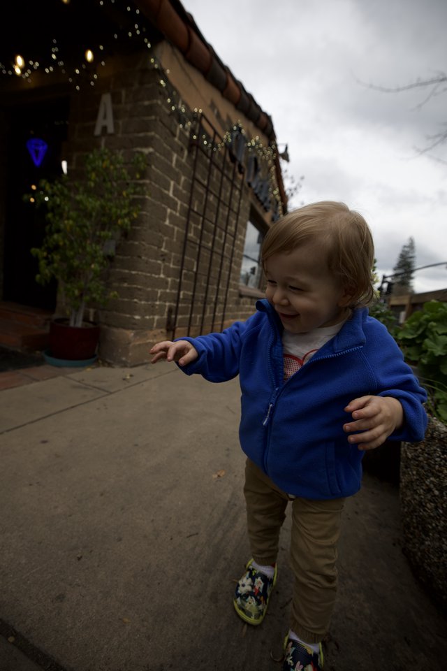 Toddler Exploring Urban Backyard on Cloudy Day