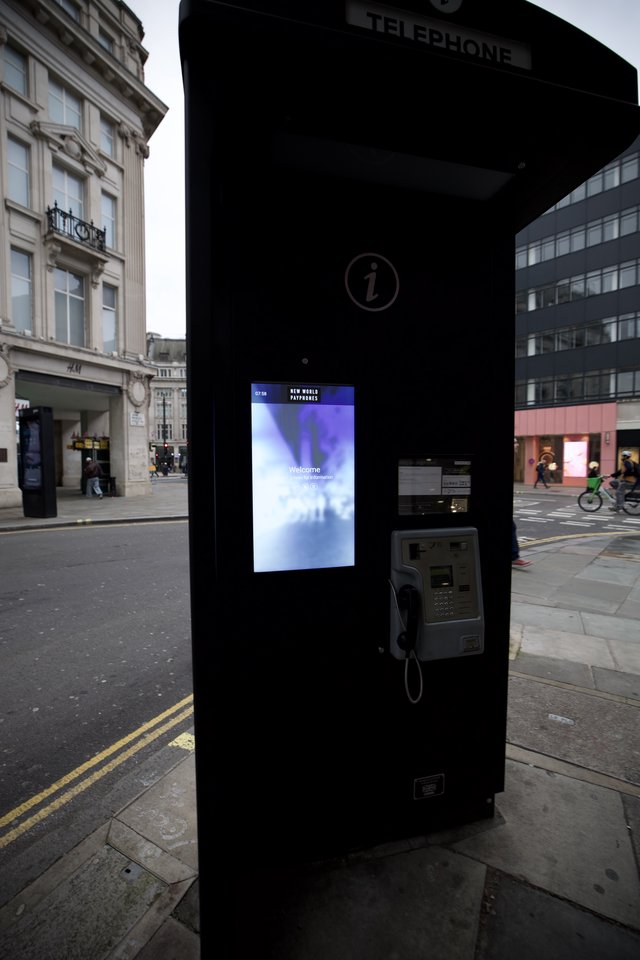 Modern Phone Booth with Digital Screen in London Street